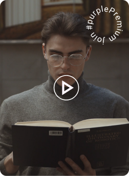 Student with glasses reading a book